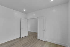 Unfurnished flex room featuring light wood-type flooring and recessed lighting