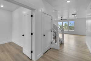 Hall featuring recessed lighting, light wood-type flooring, and stairway