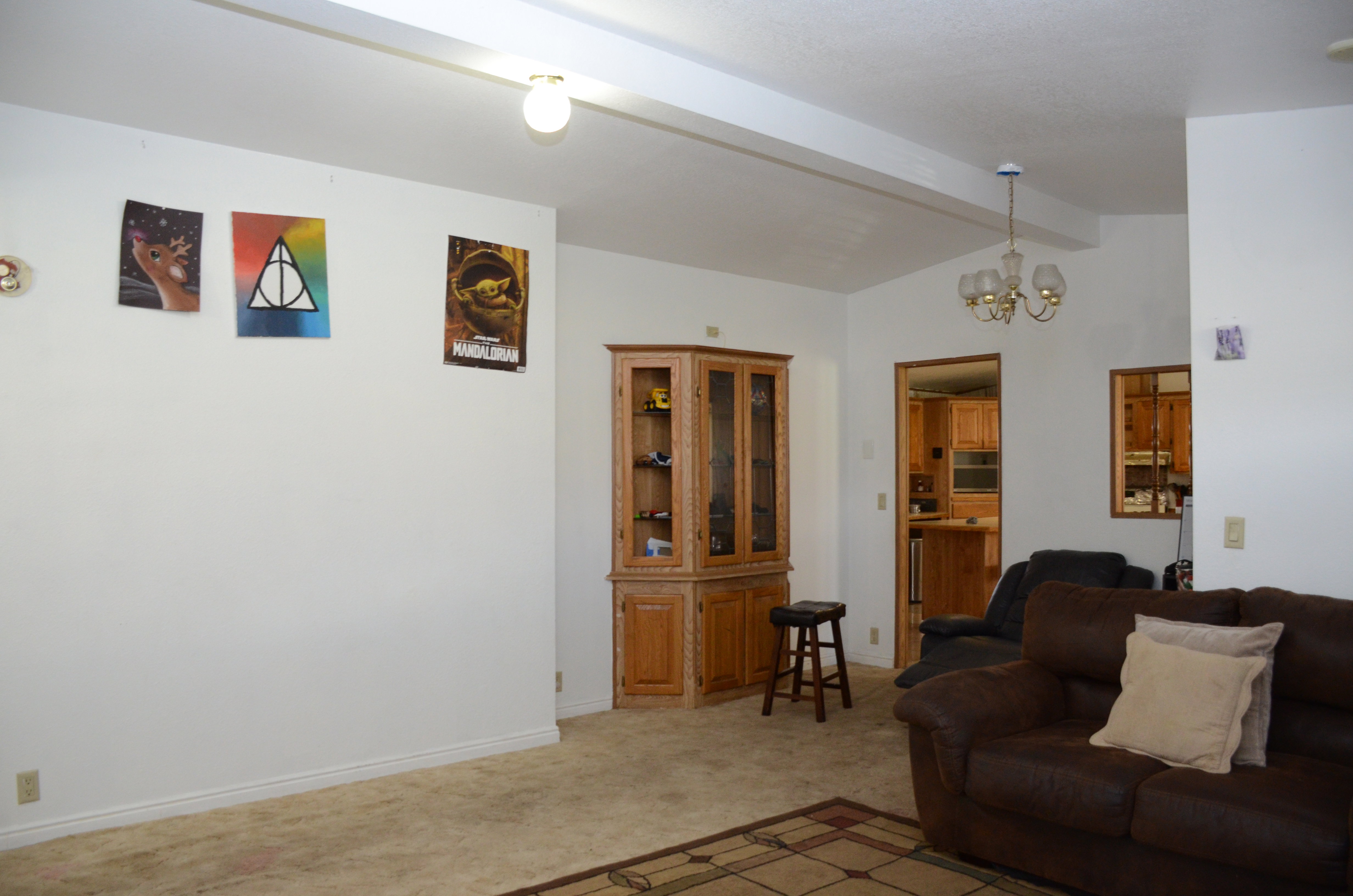 Living area featuring a chandelier and light colored carpet