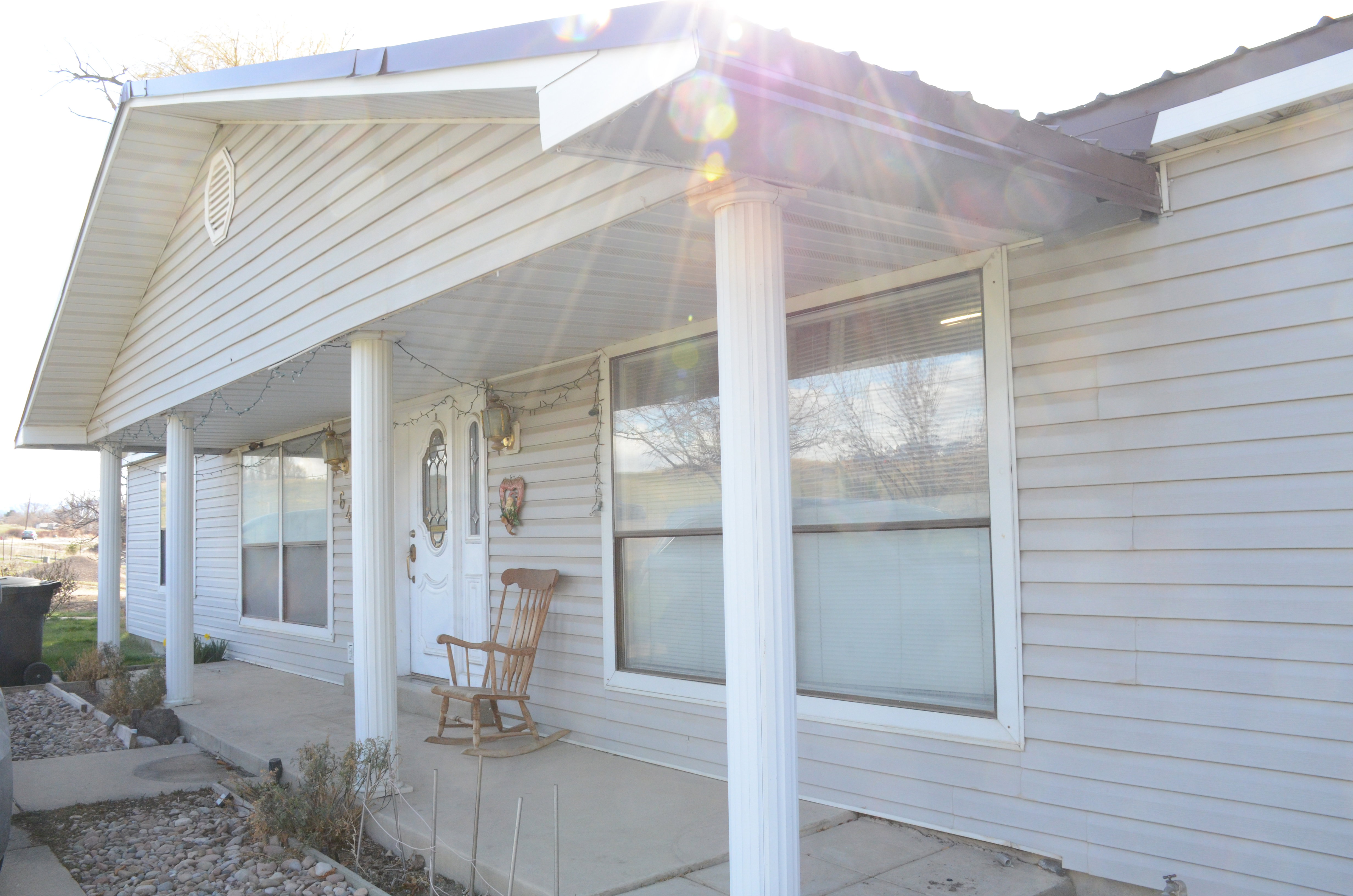 Entrance to property with a porch, facing East