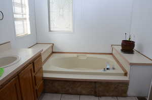 Bathroom with a bath and vanity