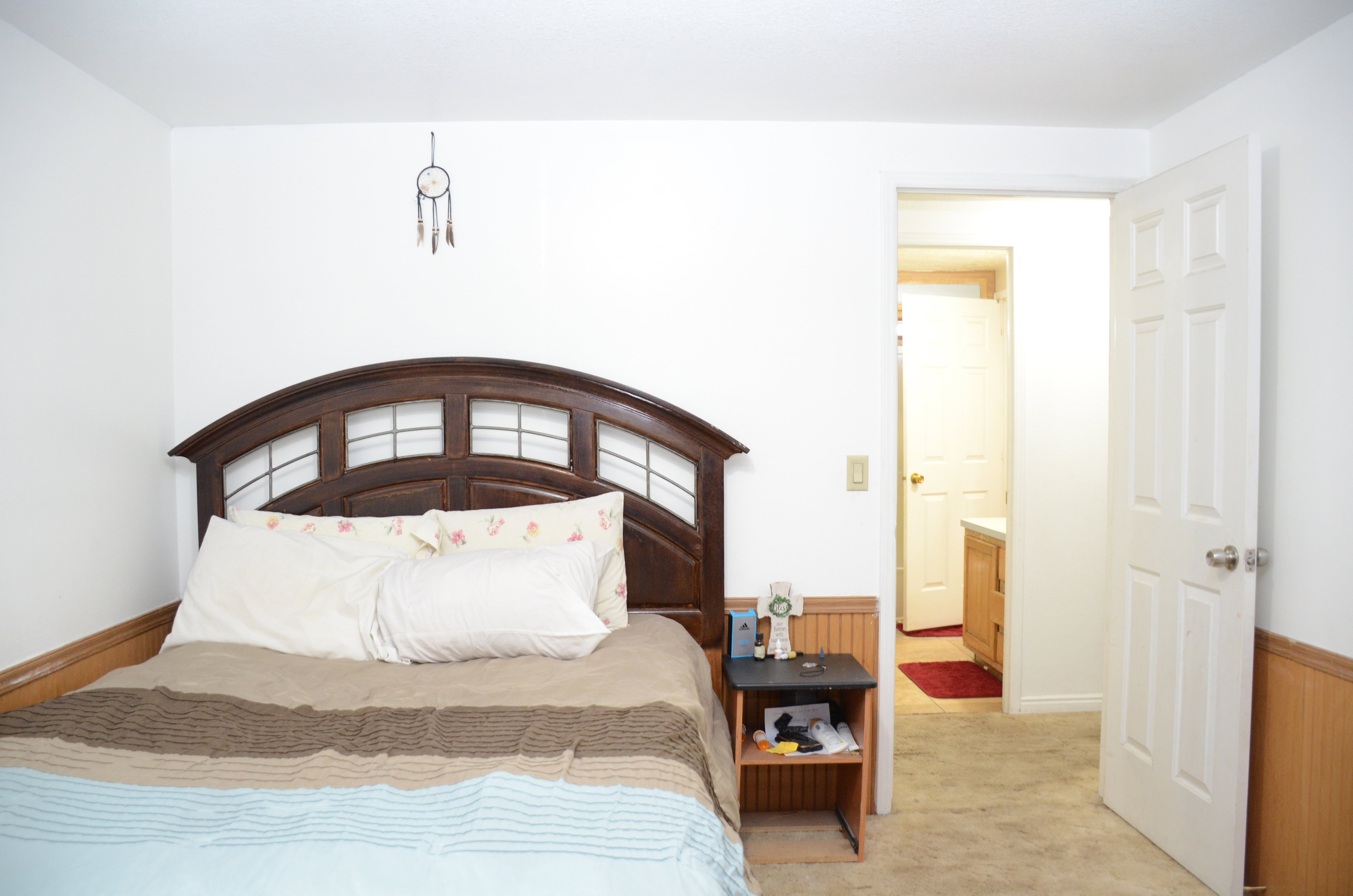 Bedroom featuring light carpet