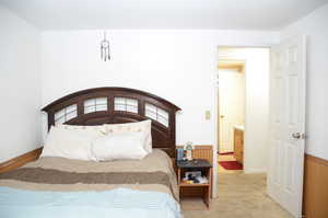 Bedroom featuring light carpet