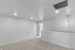 Spare room with light carpet and recessed lighting