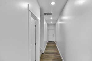 Corridor with recessed lighting and light wood-style floors