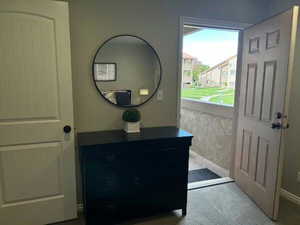 Doorway featuring baseboards