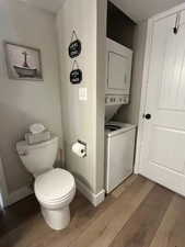 Bathroom with light wood finished floors and estacked washer and dryer