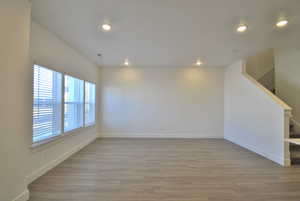 Living Room with light wood-style flooring, recessed lighting, and stairway