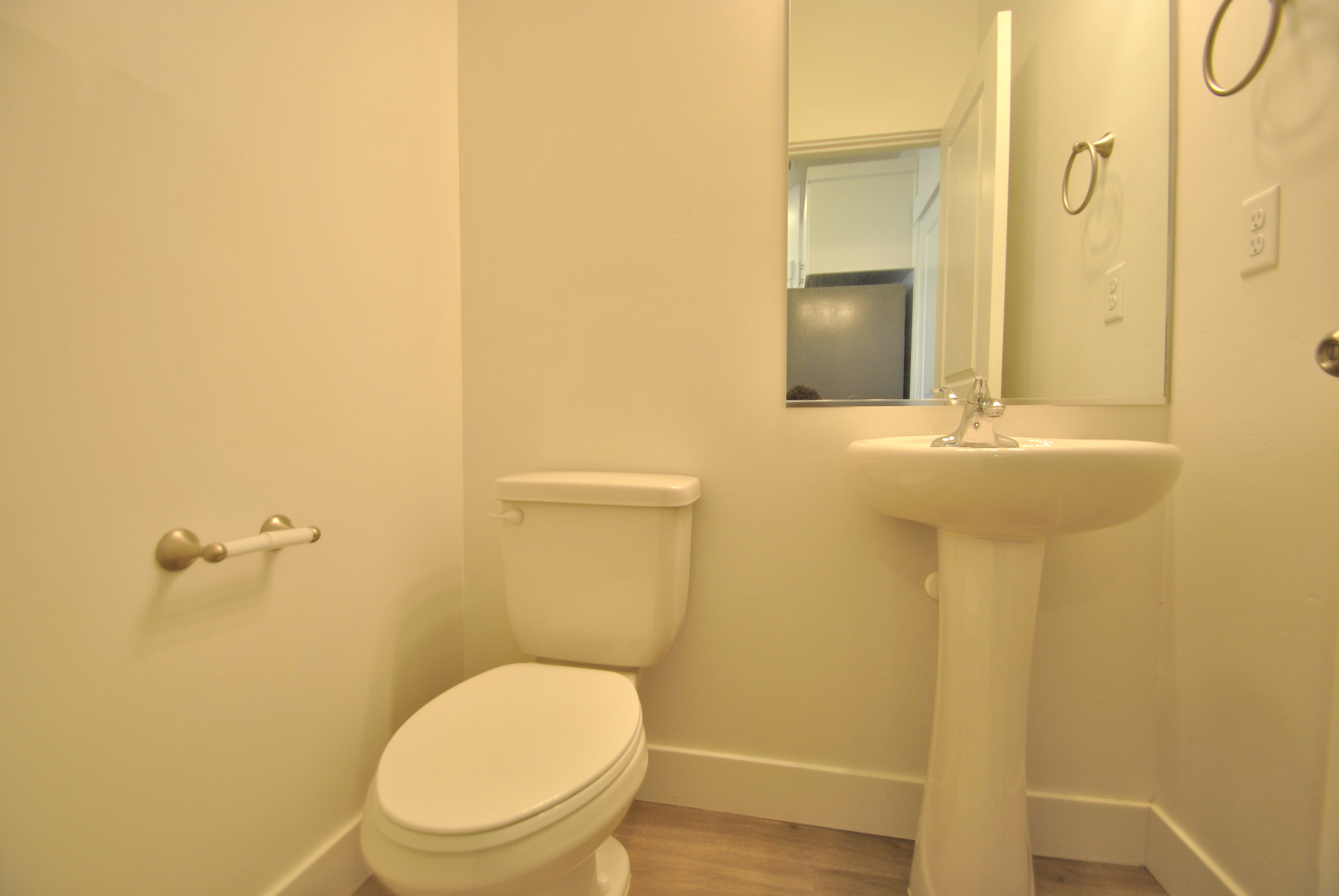 Half bathroom featuring baseboards and wood finished floors