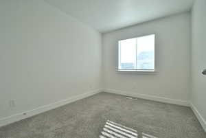 Bedroom featuring carpet flooring and baseboards