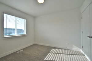 Bedroom featuring baseboards and carpet flooring