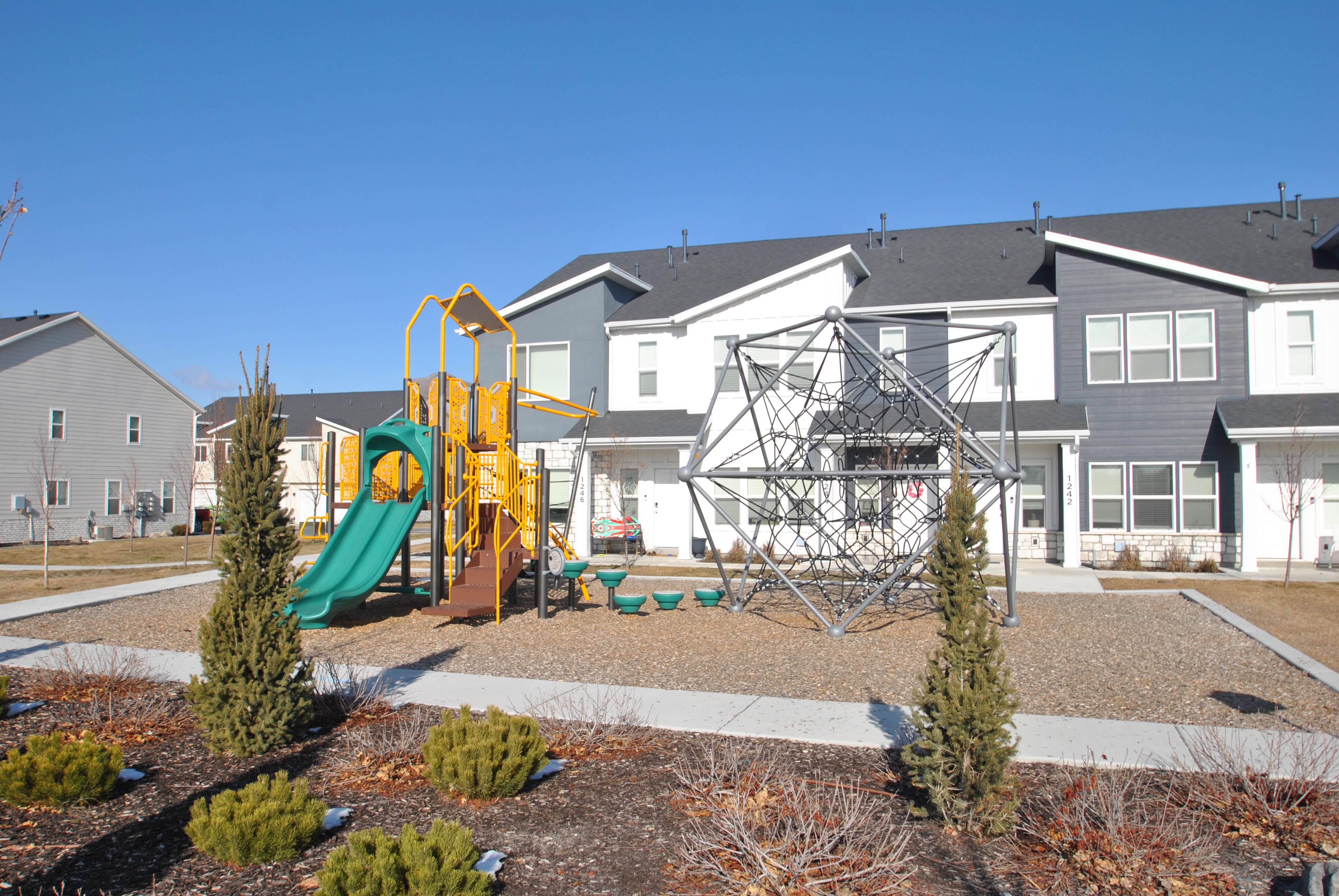 Community jungle gym located across the community street from the home.