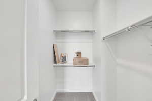 Spacious closet with light colored carpet