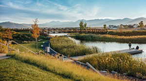 Water view featuring mountains and a floating dock