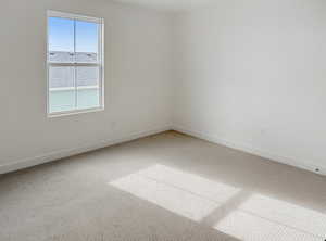 Unfurnished room featuring carpet and baseboards