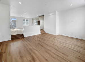 Unfurnished living room with recessed lighting and light wood-style flooring