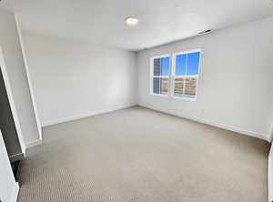 Unfurnished room with carpet flooring and baseboards