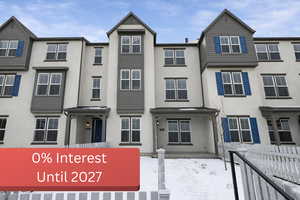 View of front of home with stucco siding and a residential view