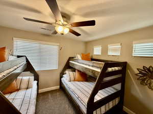 Carpeted bedroom with single over Double Bunkbeds, baseboards and ceiling fan