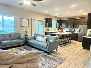 Living area with light wood-style floors, recessed lighting, and ceiling fan