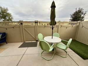 View of patio / terrace featuring outdoor dining area and a gate
