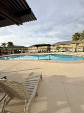Community pool featuring a patio