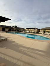 Community pool featuring a patio