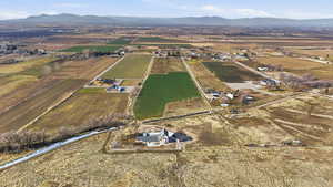 Aerial view of property and surrounding area featuring rural landscape and mountains