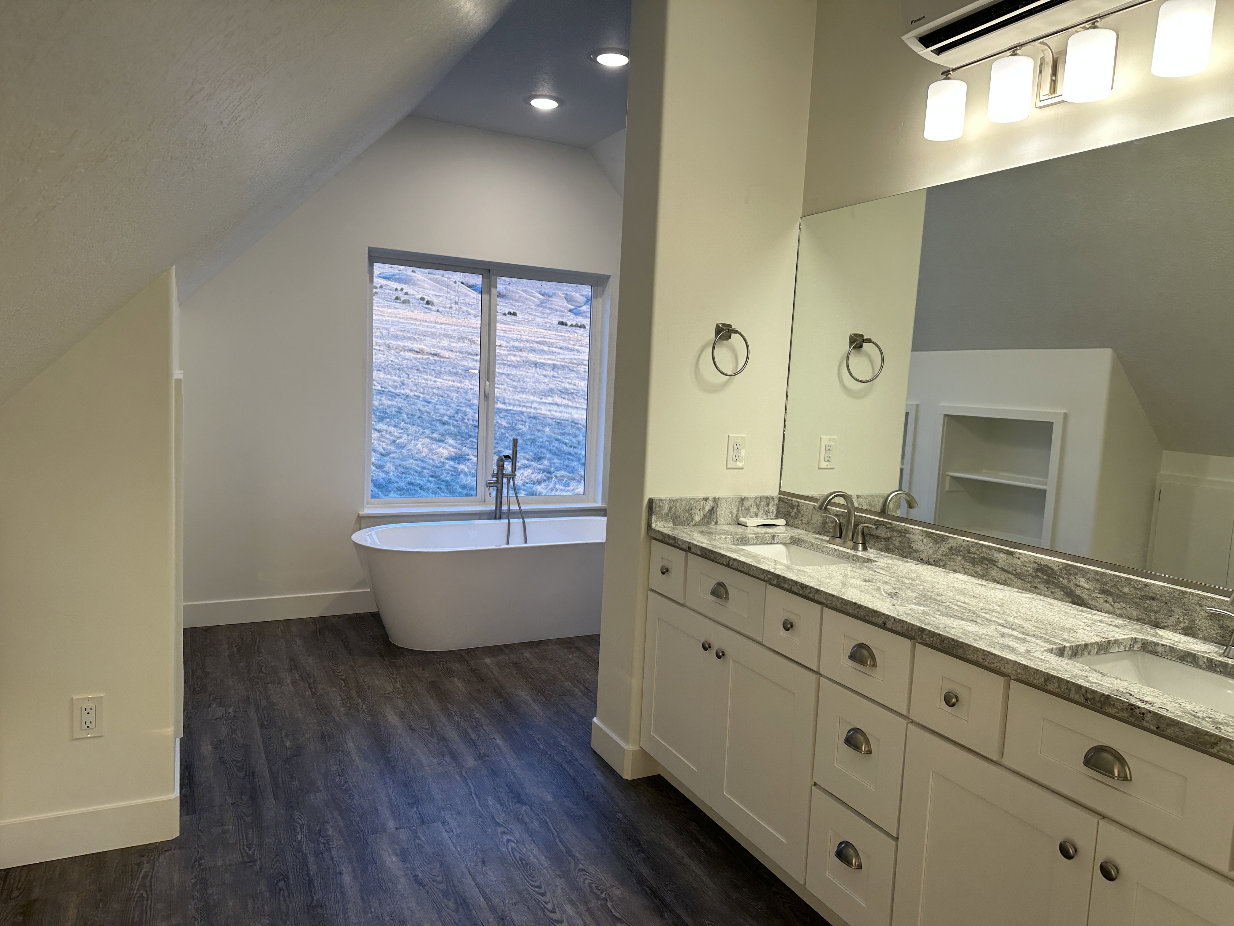 Full bath with double vanity, a freestanding tub and separate shower