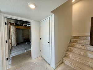 Stairs with a textured ceiling