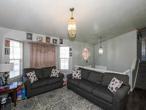 Living room featuring stairway and wood finished floors