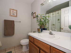 Bathroom featuring a shower with curtain, vanity, and light tile patterned flooring