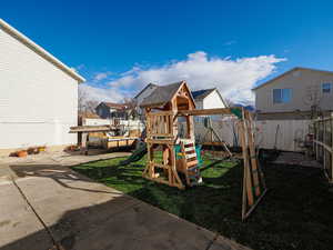 View of play area with a fenced backyard and a residential view