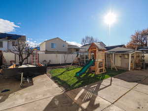 View of play area featuring a fenced backyard and a residential view