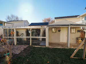 View of grassy yard featuring an outdoor structure and a patio area