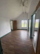 Bonus room featuring a ceiling fan, dark wood-style flooring, beamed ceiling, and a textured ceiling