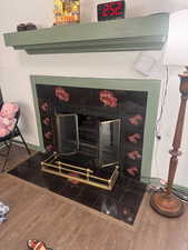 Detailed view of a fireplace and wood finished floors