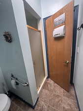 Bathroom featuring a stall shower and toilet