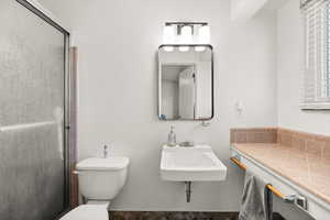 Full bath with a shower stall and toilet