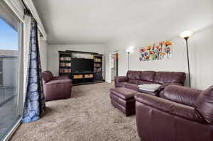 Living room with carpet floors and a textured ceiling
