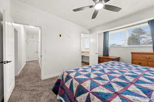 Carpeted bedroom with a textured ceiling and a ceiling fan