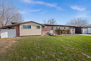 Single story home with brick siding, an attached garage, and driveway