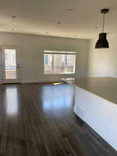 Unfurnished living room with dark wood finished floors