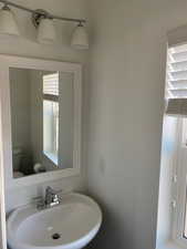 Half bath featuring a sink and toilet