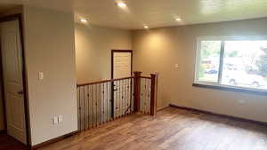 Spare room featuring wood-type flooring and recessed lighting
