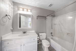 Full bath with shower / tub combination, vanity, and light tile patterned floors