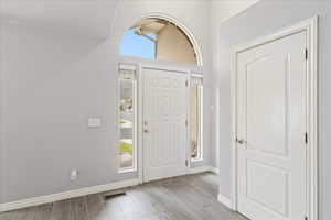 Entrance foyer featuring plenty of natural light and light wood-style flooring