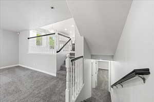Staircase with carpet floors, a textured ceiling, and recessed lighting