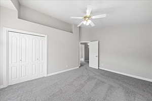 Unfurnished bedroom with carpet flooring, a closet, and ceiling fan