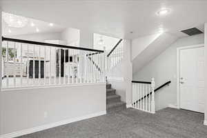 Stairway featuring a textured ceiling, carpet flooring, recessed lighting, and ceiling fan